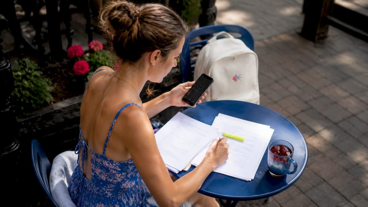 Woman practicing CELPIP timing at kitchen table