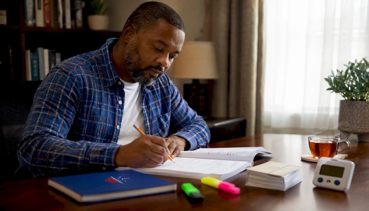 Man taking English proficiency assessment at library table