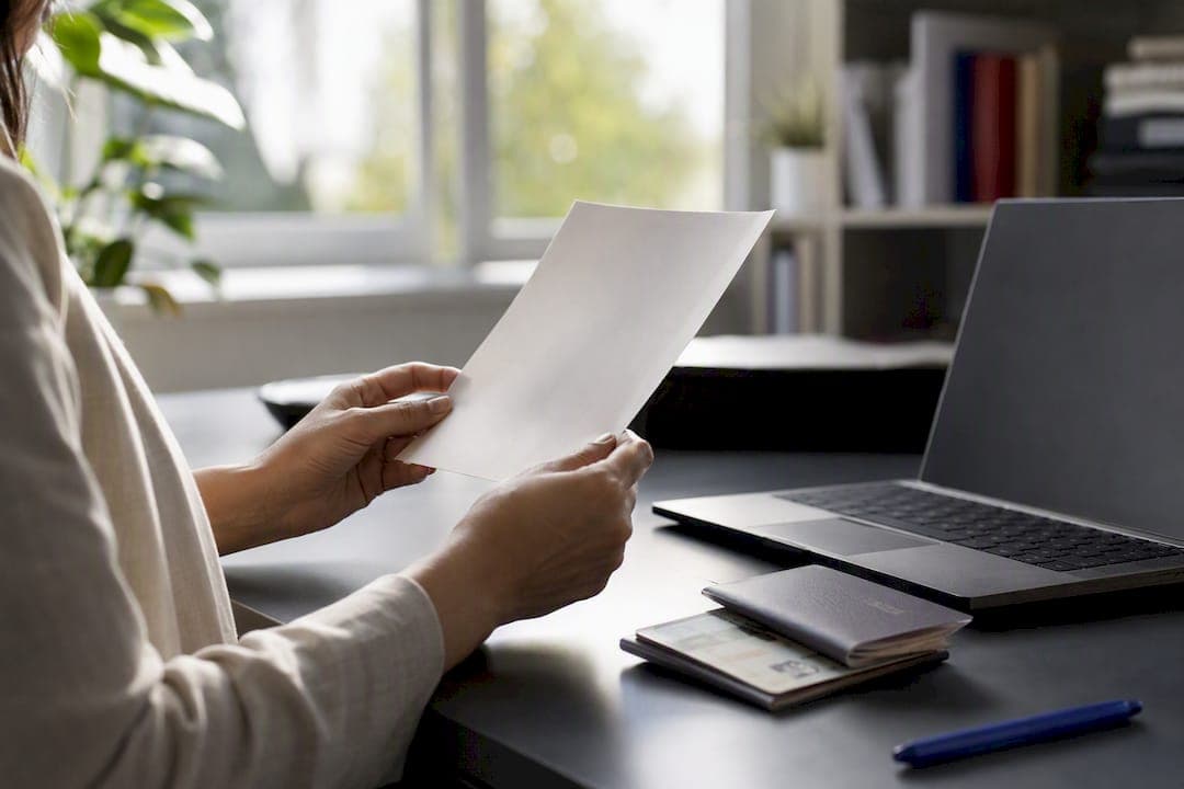 Hands holding CELPIP result letter at desk